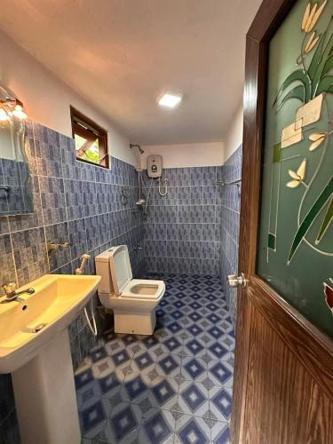 a bathroom with a toilet and a sink at R BackPacker Hostel in Ahangama