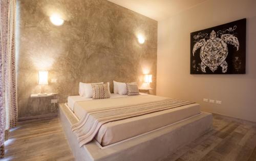 a bedroom with a large bed in a room at Kobe Suite Resort in Watamu