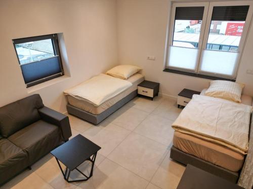 a living room with two beds and a couch at Hotels-in-Alsdorf in Alsdorf