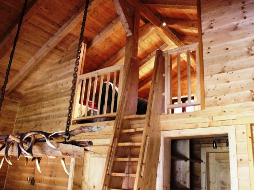 a wooden cabin with stairs in the ceiling at Feriendorf X-Alp Lodges Ötztal in Sautens