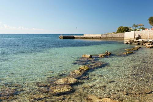 a body of water with rocks in the water at Mobile Homes - FKK Nudist Camping Solaris in Poreč