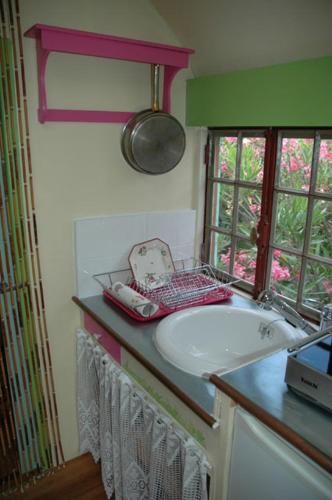 a bathroom with a white sink and a window at L'Amandari - Chambres d'hôtes in Plan-de-la-Tour