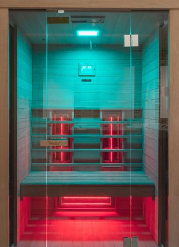 a glass case with red lights in a room at Delanta Panzió in Pécs