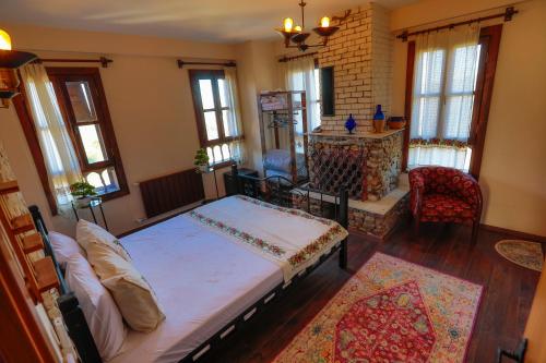 a bedroom with a large bed in a room with windows at İkiz Konaklar in Selçuk