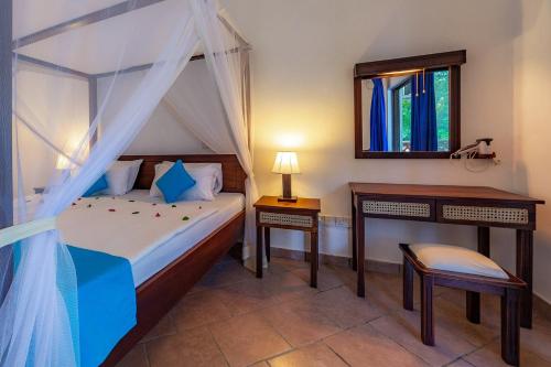 a bedroom with a bed and a desk and a mirror at Empiris Lodge in Sekenani