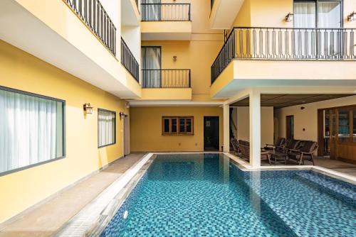 a swimming pool in the middle of a building at Lumi Hội An Hotel in Hoi An