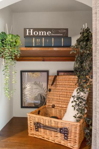 a room with a basket and books on a shelf at Ramsay Lane in Lossiemouth