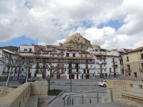 a building with a mountain in the background at Casa Rural Vistes de Morella in Morella