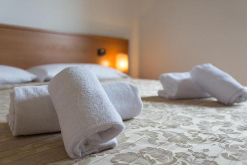 a group of towels sitting on a bed at Residence La Margherita in Lazise