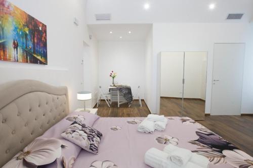a bedroom with a large bed with flowers on it at Premiere Luxury Catania in Catania