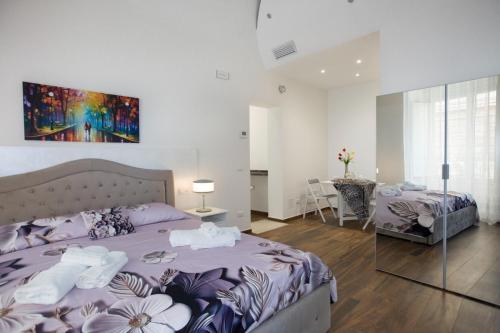a bedroom with two beds and a table at Premiere Luxury Catania in Catania