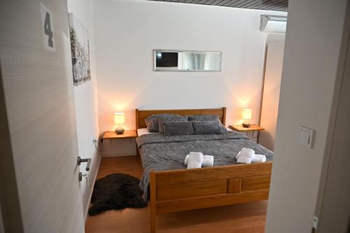 a bedroom with a bed with two towels on it at Sobe i apartmani MILLA in Slavonski Brod