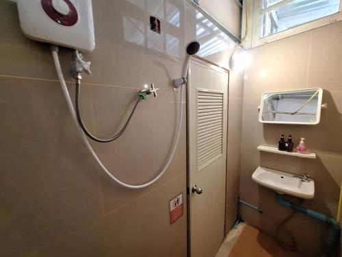 a bathroom with a shower and a sink at Sabai Sabai Bed in Pai