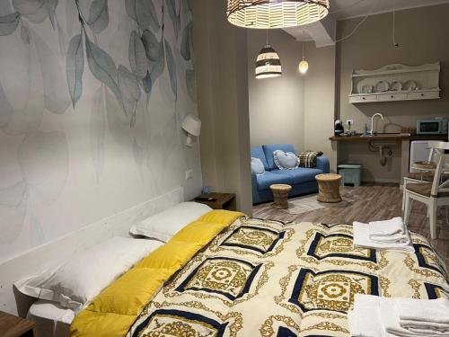 a bedroom with a bed and a blue chair at le Piagge in Viterbo