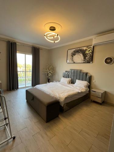 a bedroom with a bed and a large window at شاليه درة العروس in Durat Alarous