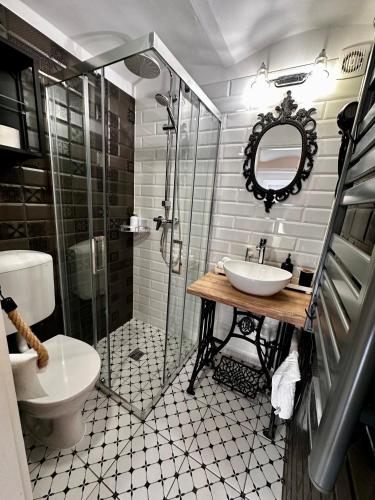 a bathroom with a toilet and a sink and a shower at Petőfi Sarok Apartman in Keszthely