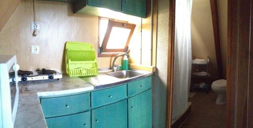 a small kitchen with a sink and a window at Góis Camping in Góis