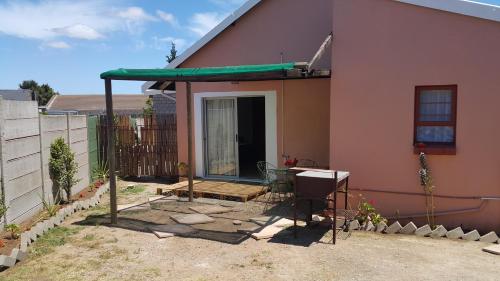 a house with a porch with a green roof at Westcoast Central Budget accommodation in Vredenburg