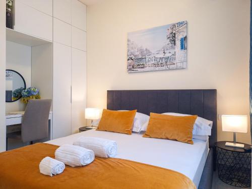 a bedroom with a large bed with orange pillows at Villa TeSa in Sevid