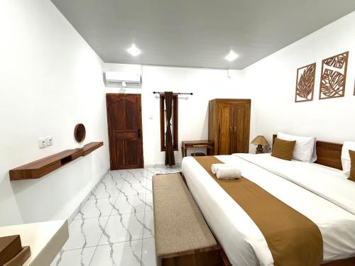 a bedroom with a large bed in a room at Lestari Homestay Jimbaran in Jimbaran