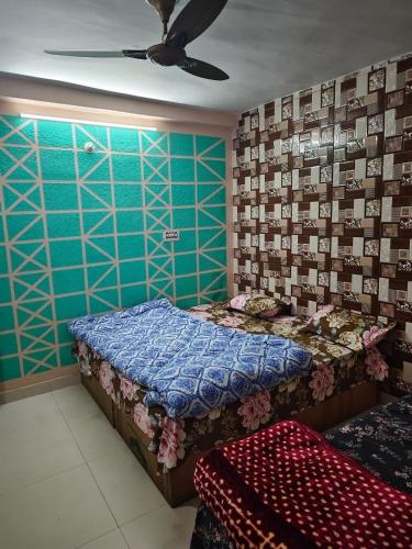a bedroom with a bed and a ceiling fan at ONLY CAFE Hotel in Chopta