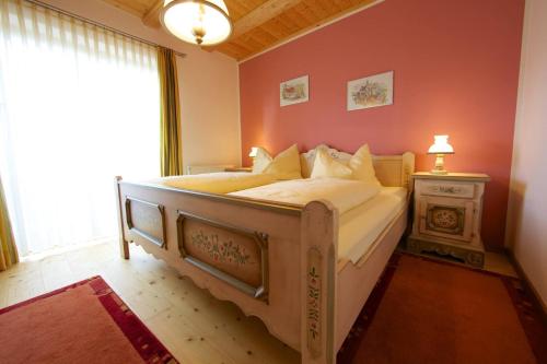 a bedroom with a bed in a room with a window at Almhaus Karantanien in Hochrindl