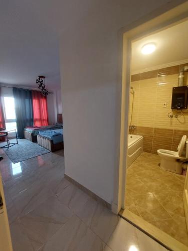 a room with a bathroom with a tub and a toilet at Madinaty B12 Guesthouse Shared Apartment - Garden View in Madinaty