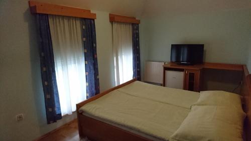 Postel nebo postele na pokoji v ubytování Penzion Zeleni Kakadu
