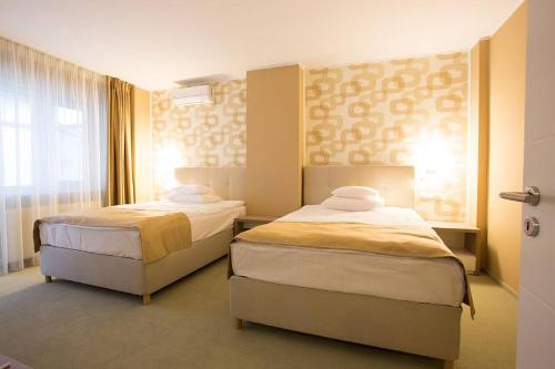Postel nebo postele na pokoji v ubytování Bruxelles Guesthouse Craiova