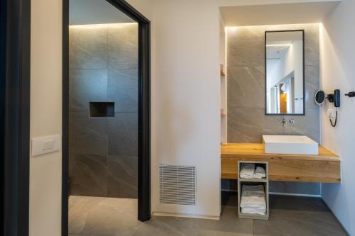 a bathroom with a sink and a mirror at Alissachni SeaSide Hotel in Derveni