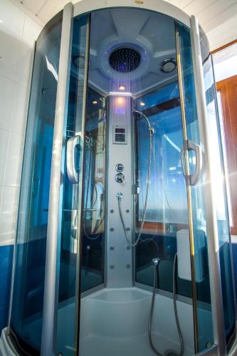 a bathroom with a shower in a train at Panorama Top Floor Rooms in Hotel Tundzha in Yambol