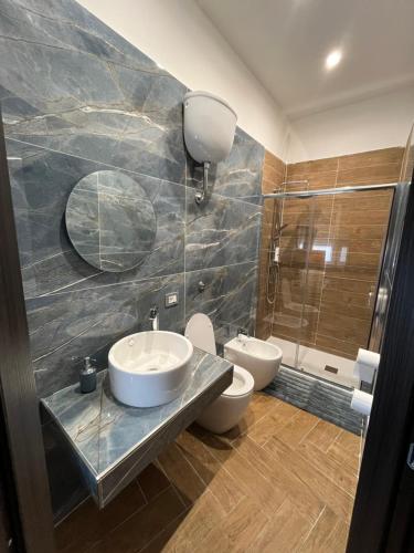 a bathroom with two sinks and a shower at Domus Anna in Bacoli