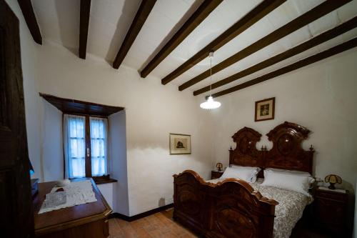 a bedroom with a wooden bed and a window at B&B Cortebonomini apartment in Neviano degli Arduini