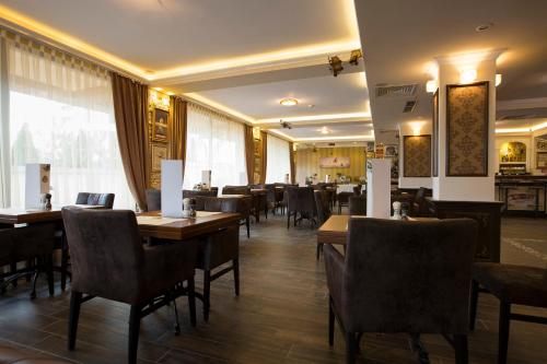 a dining room with wooden tables and chairs at Hotel Aviator Boutique in Otopeni