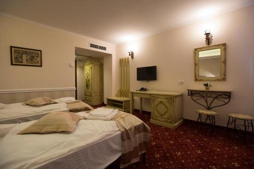 a hotel room with two beds and a mirror at Hotel Aviator Boutique in Otopeni