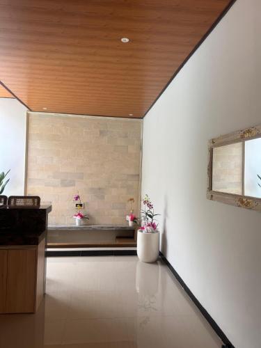 a living room with a brick wall and a window at Griya Becik Lovina - Private Pool Villa near Lovina Dolphin Spot in Lovina