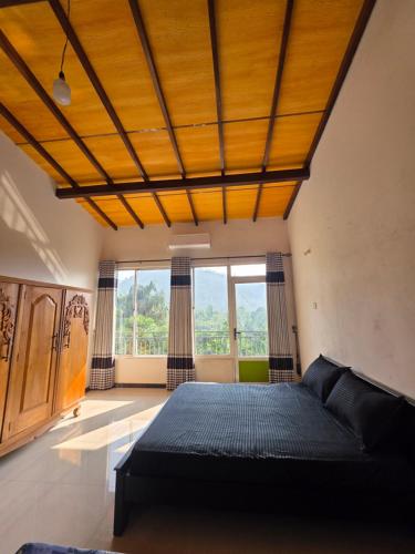 a bedroom with a bed with a wooden ceiling at X38 Venture in Kitulgala