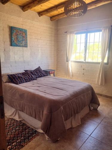 a bedroom with a large bed in a room at Casa Munay para dos personas in Uspallata