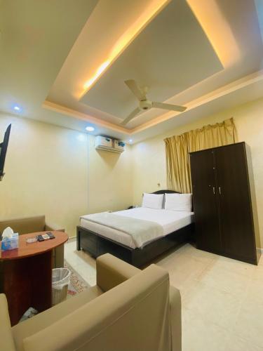 a hotel room with a bed and a couch at AL FANAR REST HOUSE LLC in Ras al Khaimah