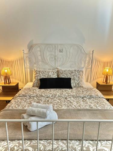 a bedroom with a large white bed with two lamps at Stou Stefani in Agros