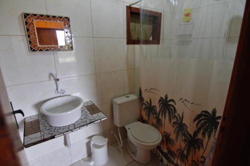 a bathroom with a sink and a toilet at Sunset Lagoon Praia do Rosa in Praia do Rosa