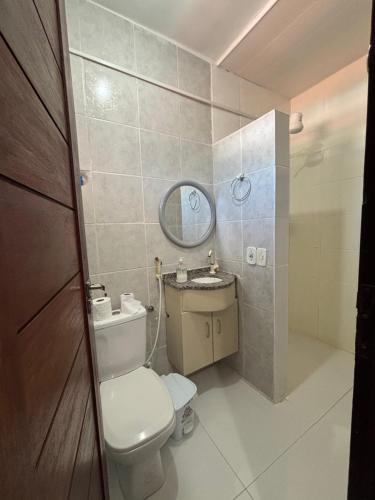 a small bathroom with a toilet and a mirror at Apartamento na Praia do Francês AL in Praia do Frances