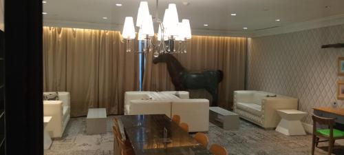 a dining room with a table and a horse statue at Knightsbridge Residences with Free Pool, Sauna, Fast WiFi, Gym and Kitchen in Manila