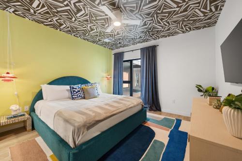a bedroom with a bed with a blue headboard at Hyve in Nashville