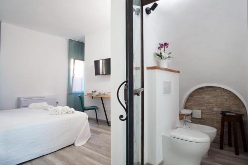 a bathroom with a bed and a toilet and a sink at B&B da Baba in Ghizzano