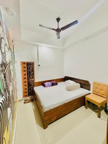 a bedroom with a bed and a ceiling fan at Mannat Lodge in Hailākāndi