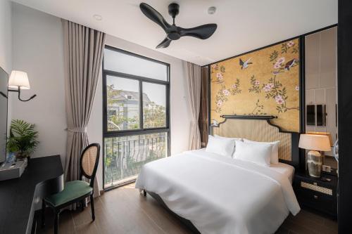 a bedroom with a large bed and a window at AviCasa T21 in Gò Công