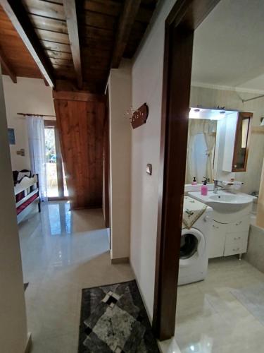 ein Badezimmer mit Waschbecken und Waschmaschine in der Unterkunft Optasia in Karpenisi