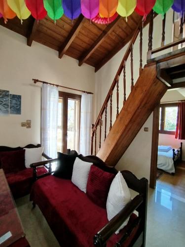 ein Wohnzimmer mit Sofa und Treppe in der Unterkunft Optasia in Karpenisi