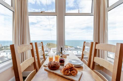 a dining room with a table with a view of the ocean at Ocean View in Ilfracombe
